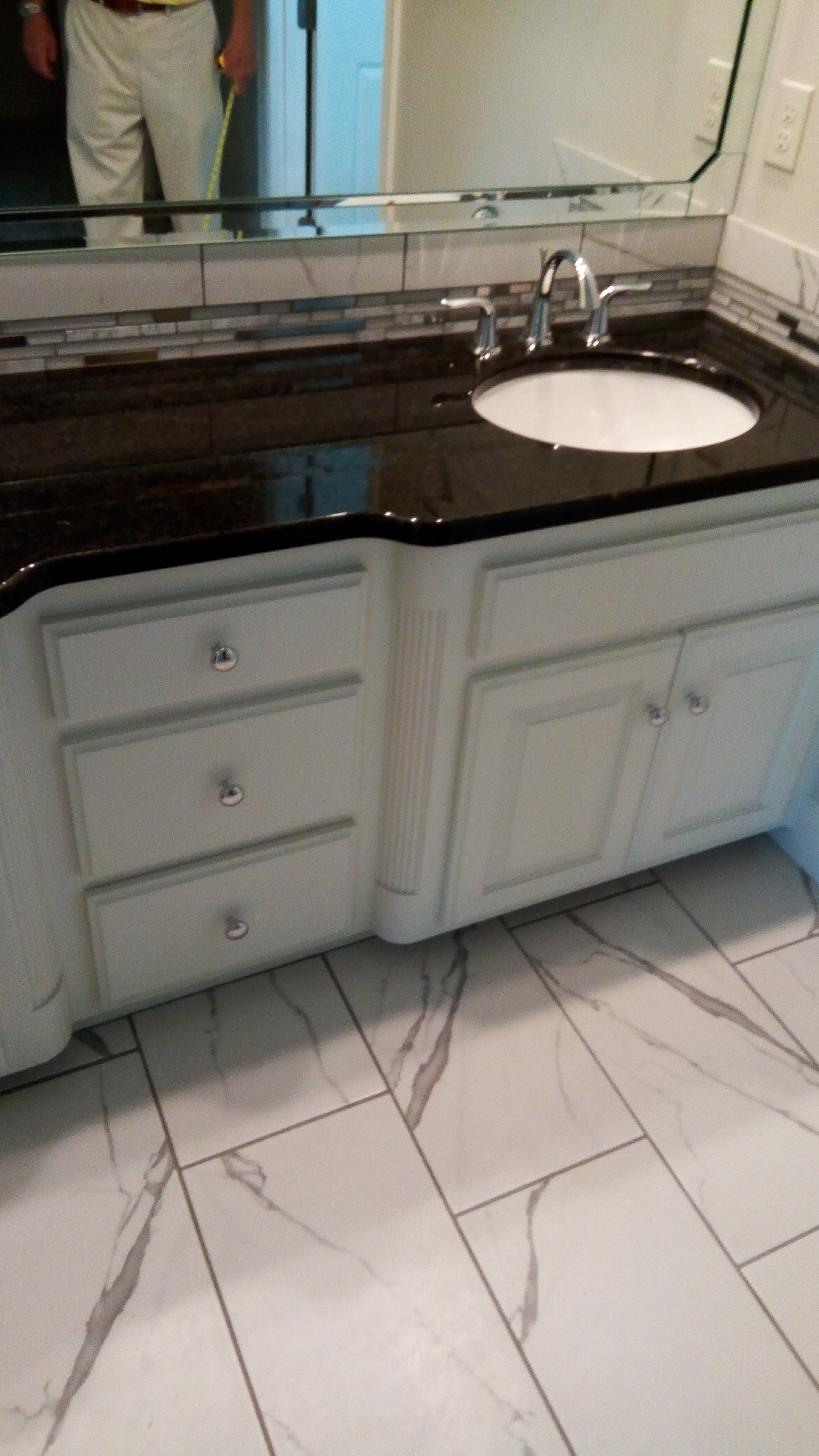 Finished bathroom vanity with black granite countertop